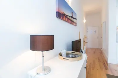 a room with a table with a lamp on it at Santa Catarina Views by Porto City Hosts in Porto