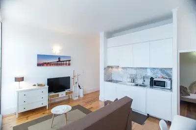 a living room with a couch and a tv at Santa Catarina Views by Porto City Hosts in Porto