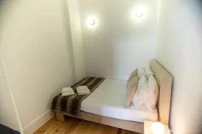 a small room with a bed with two pillows at Santa Catarina Views by Porto City Hosts in Porto