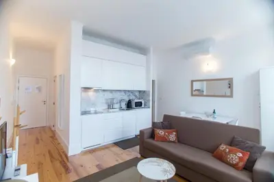 a living room with a couch and a kitchen at Santa Catarina Views by Porto City Hosts in Porto