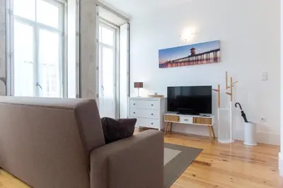 a living room with a couch and a television at Santa Catarina Views by Porto City Hosts in Porto