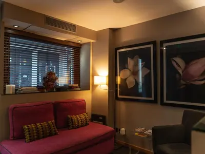 a living room with a red couch and a window at Guest House Douro in Porto