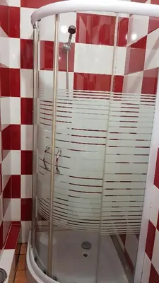 a shower in a bathroom with a red and white checkered wall at Oporto Beauty Flat in Porto