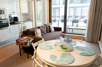 a kitchen and living room with a table and chairs at Casas do Teatro in Porto