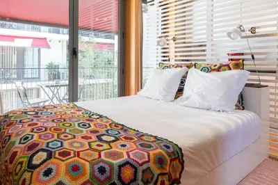 a bedroom with a large bed and a balcony at Casas do Teatro in Porto