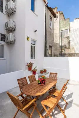 a wooden table and two chairs on a patio at ZD Moreira Flats C By PortoProperties4You in Porto