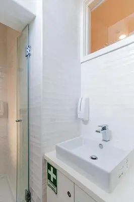 a white bathroom with a sink and a shower at ZD Moreira Flats C By PortoProperties4You in Porto