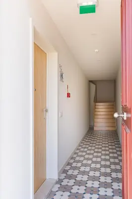 an empty hallway with a door and a tile floor at APOSENTUS - The Wine Studio in Porto
