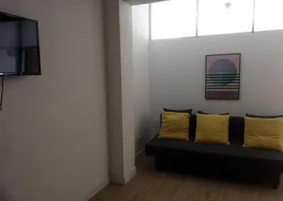 a living room with a couch with two yellow pillows at Camões Lookout in Porto