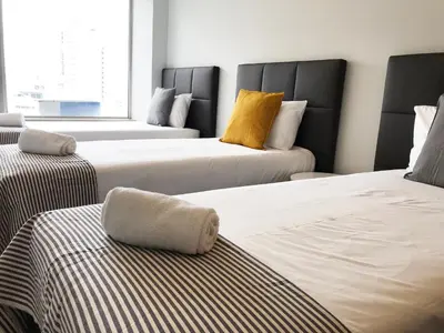 a room with three beds in a room at Camões Lookout in Porto