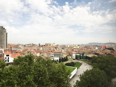 a view of a city with buildings and trees at Camões Lookout in Porto