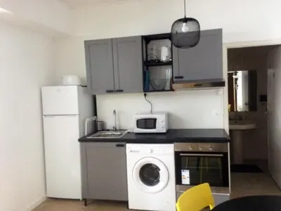 a kitchen with a washing machine and a refrigerator at Camões Lookout in Porto