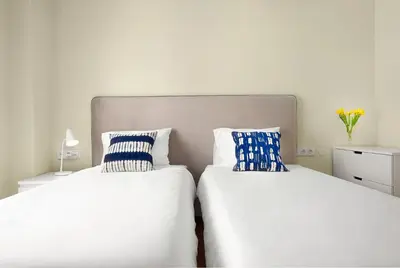 two beds sitting next to each other in a bedroom at Big Families & Groups Bonjardim views 5 bedrooms 3 bathrooms in Porto