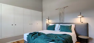 a bedroom with a large bed with green pillows at Oporto Serviced Apartments - Miragaia in Porto