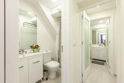 a white bathroom with a toilet and a sink at D&S - Torne Apartments in Vila Nova de Gaia