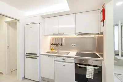 a kitchen with white cabinets and a sink at D&S - Torne Apartments in Vila Nova de Gaia