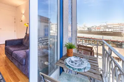 a balcony with a couch and a table at D&S - Porto São Bento Apartments III in Porto
