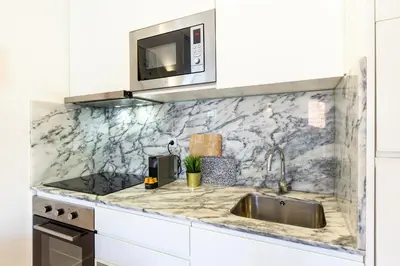 a kitchen with a sink and a microwave at D&S - Porto São Bento Apartments III in Porto