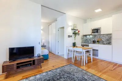a living room with a tv and a dining room table at D&S - Porto São Bento Apartments III in Porto