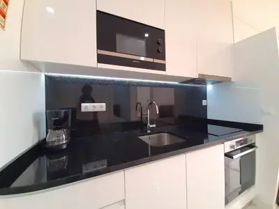 a kitchen with a sink and a microwave at VB Porto City Apartment by Flat in Porto in Porto