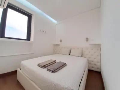 a white bedroom with a bed with two bags on it at VB Porto City Apartment by Flat in Porto in Porto