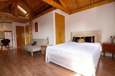 a bedroom with a white bed and a chair at Vitoria Apartments in Porto