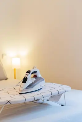 a bedroom with a bed with a gaming controller on it at Design Boavista Music Home in Porto