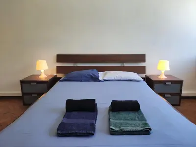 a bedroom with a large bed with two night stands at DISCOVER PORTO - Boavista in Porto
