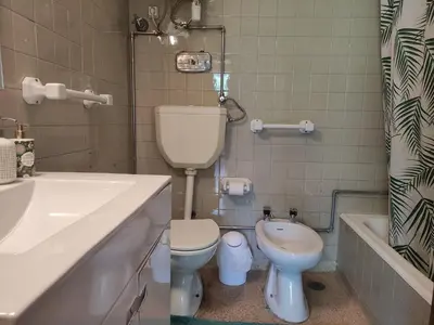 a bathroom with a toilet and a sink and a tub at DISCOVER PORTO - Boavista in Porto