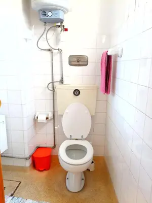 a bathroom with a toilet and a pink towel at DISCOVER PORTO - Boavista in Porto