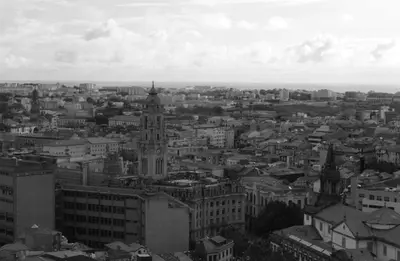 a black and white photo of a city with a clock tower at A Ilha do Lindo Vale in Porto