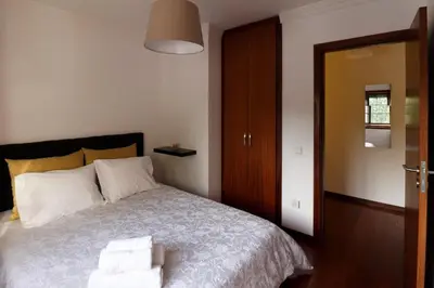 a bedroom with a bed with two towels on it at A Ilha do Lindo Vale in Porto