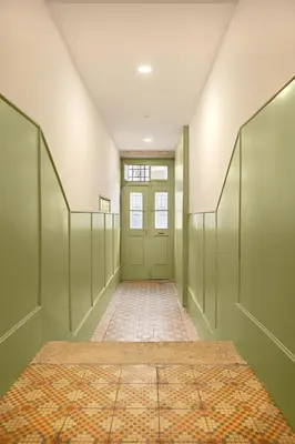 an empty hallway with a green door and a tile floor at Host Wise - Oporto Classic Apartment in Porto
