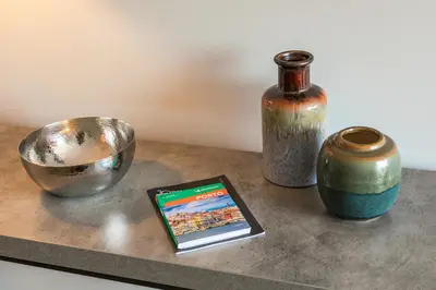 a table with a tablet next to a vase and a bowl at Porto Insight Cedofeita- Parking, Balconies & AC in Porto