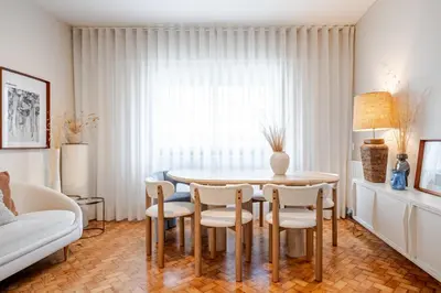 a living room with a table and chairs and a couch at UNIQUE Modernist Duplex apartment & PARKING in Porto