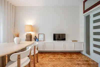 a dining room with a table and a tv at UNIQUE Modernist Duplex apartment & PARKING in Porto