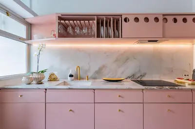 a pink kitchen with a sink and a counter at AMAZING DUPLEX - Mid Century Experience & PARKING in Porto