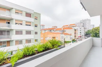 an apartment balcony with plants and buildings at AMAZING DUPLEX - Mid Century Experience & PARKING in Porto
