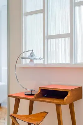 a desk with a lamp on it next to a window at INCREDIBLE DUPLEX PENTHOUSE & TERRACES & Parking in Porto