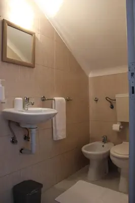 a bathroom with a sink and a toilet at Pilar home in Vila Nova de Gaia