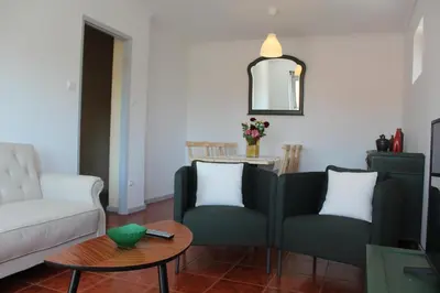 a living room with two chairs and a table at Pilar home in Vila Nova de Gaia