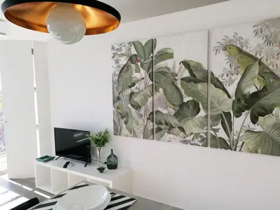 a living room with a wall mural of plants at Window Garden Apartment in Porto
