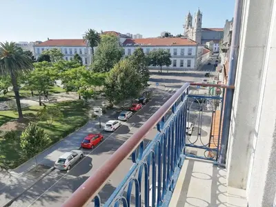a view from a balcony of a street with cars at Window Garden Apartment in Porto