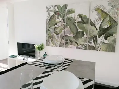 a dining room with a table and two chairs at Window Garden Apartment in Porto