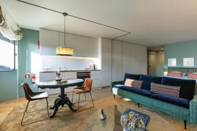 a room with doors open to a balcony with chairs at Urban Apartment Casa da Portela in Porto