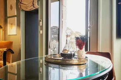 a bottle of wine and two glasses on a table at Urban Apartment Casa da Portela in Porto