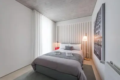 a bedroom with a bed and a large window at Cedofeita Lux Design in Porto