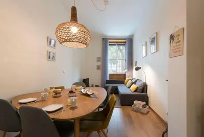 a living room with a table and a couch at LovelyStay - The Porto Getaway w/ Free Parking in Porto