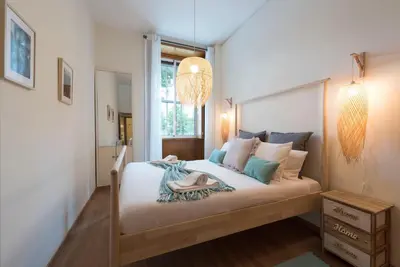 a bedroom with a large bed with a chandelier at LovelyStay - The Porto Getaway w/ Free Parking in Porto