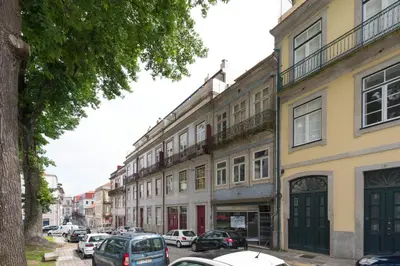 a row of buildings on a street with parked cars at LovelyStay - The Porto Getaway w/ Free Parking in Porto